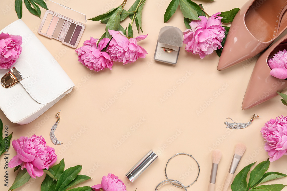 Frame made of beautiful engagement ring, accessories, cosmetics and peony flowers on color background Frame made of beautiful engagement ring, accessories, cosmetics and peony flowers on color background