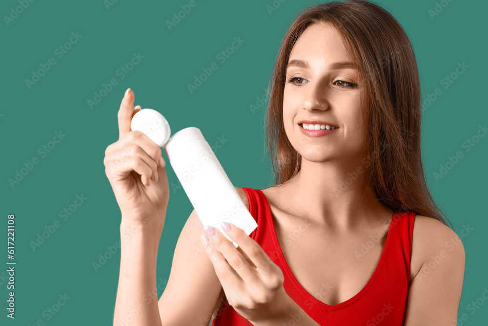 Young woman with sunscreen cream on green background, closeup Young woman with sunscreen cream on green background, closeup
