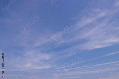 Transparent blue sky with clouds and atmospheric afternoon.