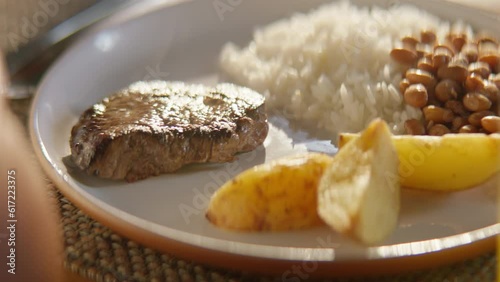 closeup of the plate with rice, beans, potato, and steak