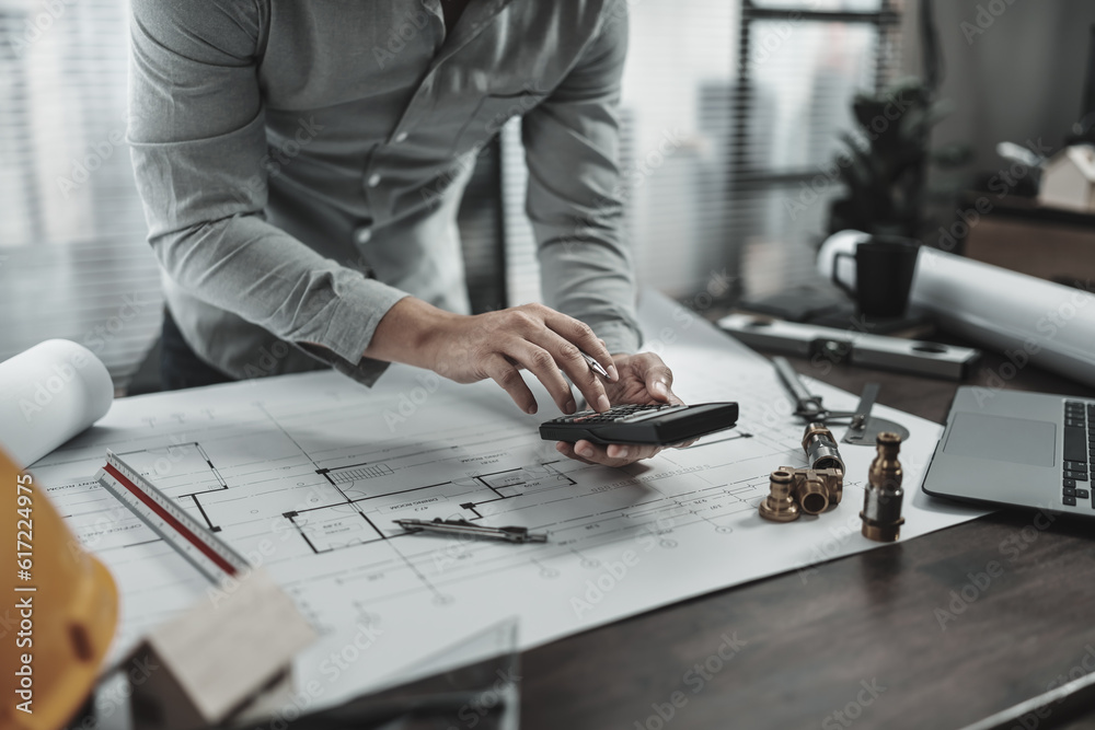 Fototapeta premium Engineering working with drawings inspection and press calculator on Blueprint. Engineer, Architect, Industry and factory concept.