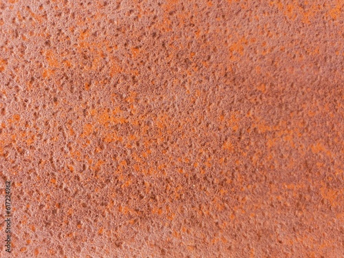 A rough surface and textured red background of a rusted metal