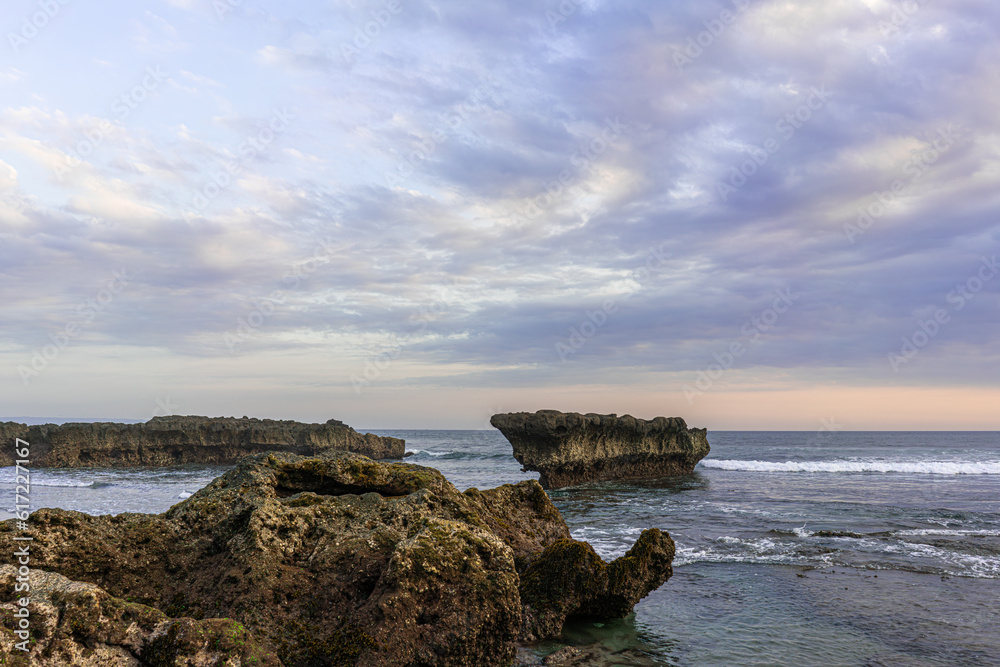 Beautiful view of the horizon, coral reefs and choppy sea on a sunny afternoon at batu bolong beach on the island of Bali