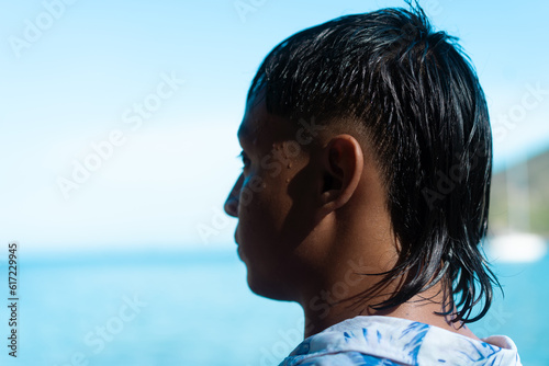 Dark-haired man on the coast