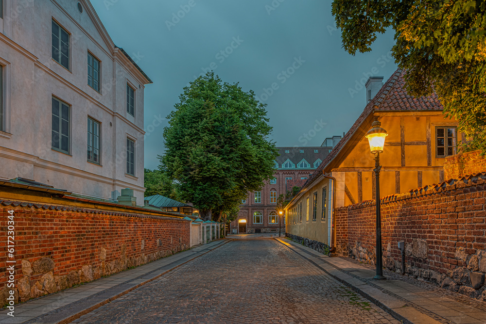 The old town of Lund in the blue hour and and picturesque illuminated alleyway The old town of Lund in the blue hour and and picturesque illuminated alleyway