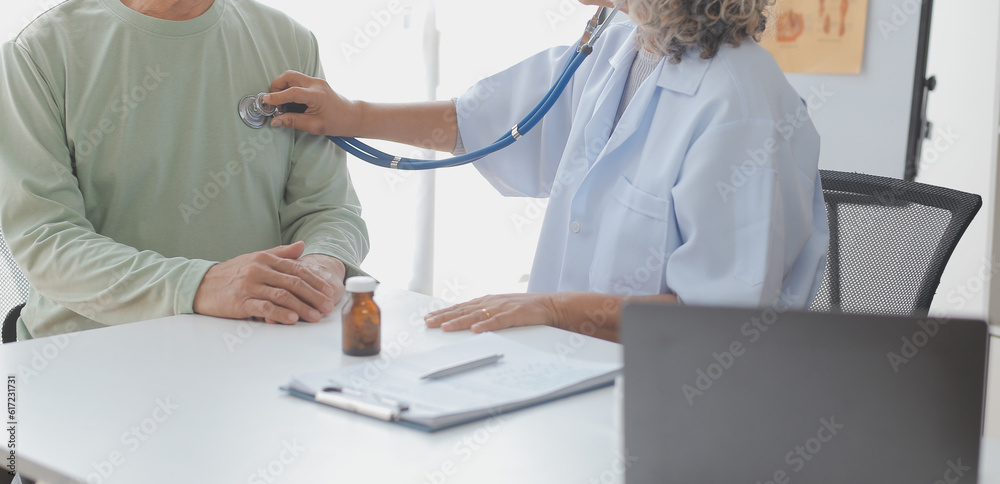 Young doctor visiting elderly woman at home