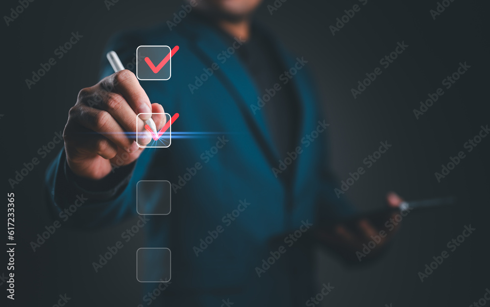 Businessman checking mark on checklist with a red checkmark. Online ...