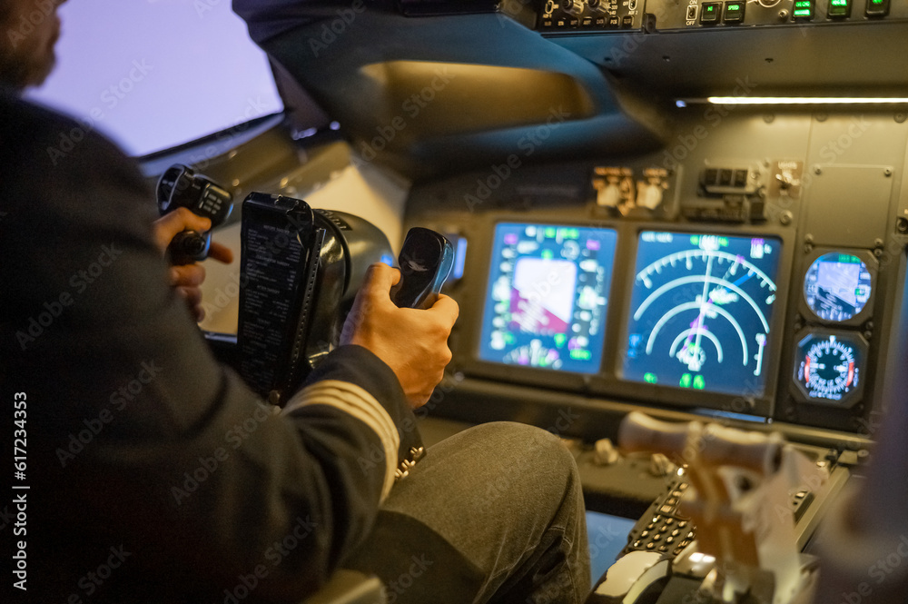 A man is studying to be a pilot in a flight simulator. Close-up of male hands navigating an aircraft. A man is studying to be a pilot in a flight simulator. Close-up of male hands navigating an aircraft.
