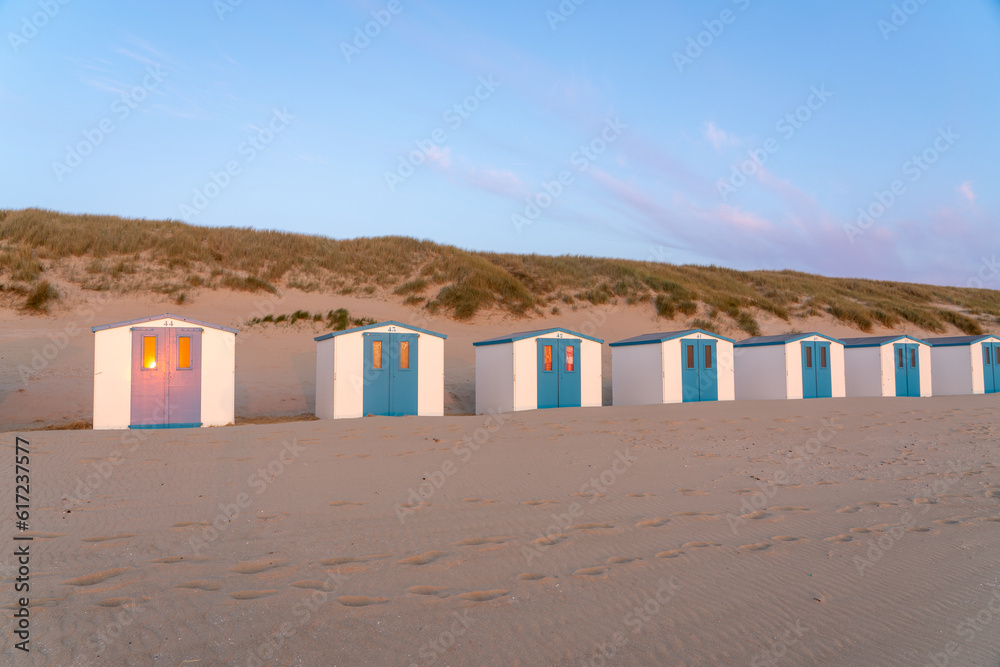 On the coast with beach huts whit the sun go down