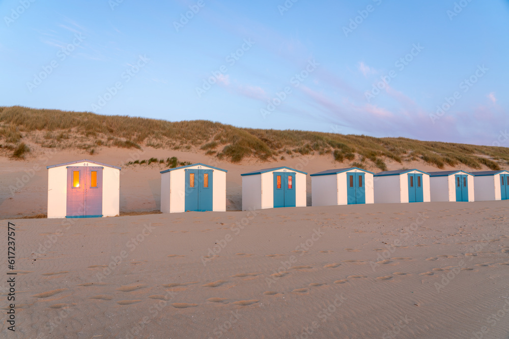 On the coast with beach huts whit the sun go down On the coast with beach huts whit the sun go down