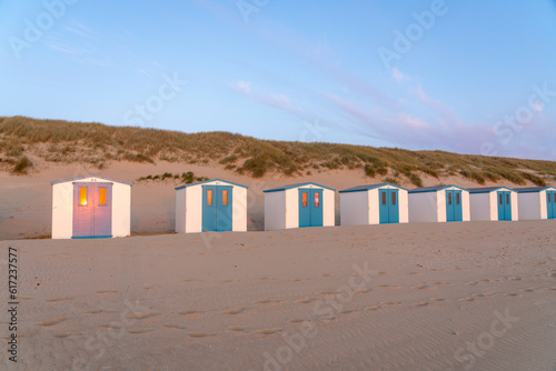 On the coast with beach huts whit the sun go down