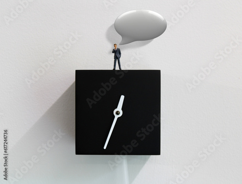 One successful business man giving advice while standing on a wall clock.
