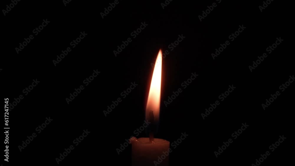 candles burning in the dark, with minimal light reflections candles burning in the dark, with minimal light reflections