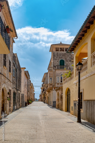 An idyllic scene of small village Petra old town, an empty narrow street lined with old facades, preserving the timeless charm of this Mediterranean gem. Balearic Islands Spain. © ArtushFoto