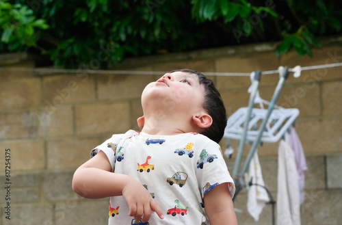 Beautiful Close up Portrait of an Asian Pakistani Baby Boy Named Ahmed Mustafain Haider is Posing at Home Garden at Saint Augustine Ave Luton, England UK. Image Was Captured on April 03rd, 2023. photo