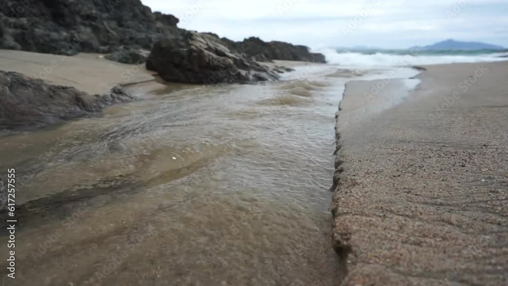 Flowing sea water, white sand, and coral reefs at Mangawhai Heads, New Zealand. Flowing sea water, white sand, and coral reefs at Mangawhai Heads, New Zealand.