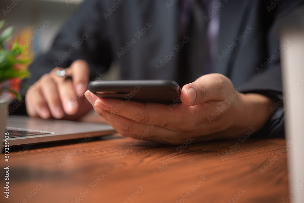 Business man using mobile smart phone management information financial documents, marketing online, job and payment digital technology on desk. Business man using mobile smart phone management information financial documents, marketing online, job and payment digital technology on desk.