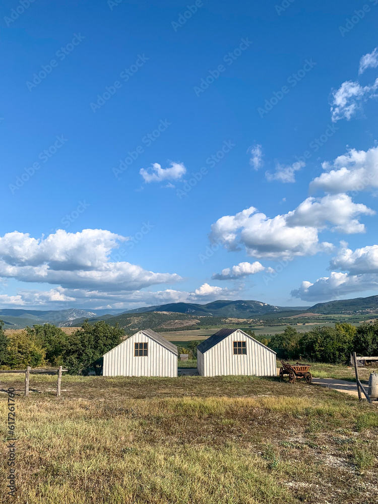  Two farmhouses and the fields between the mountains 
