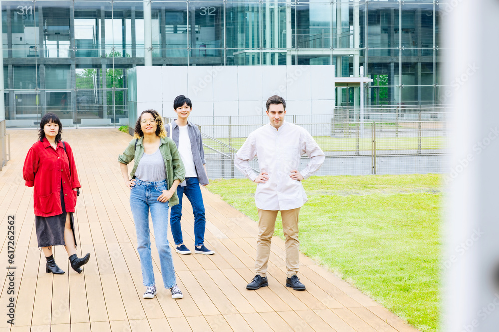 Group of multinational young people standing in college campus.