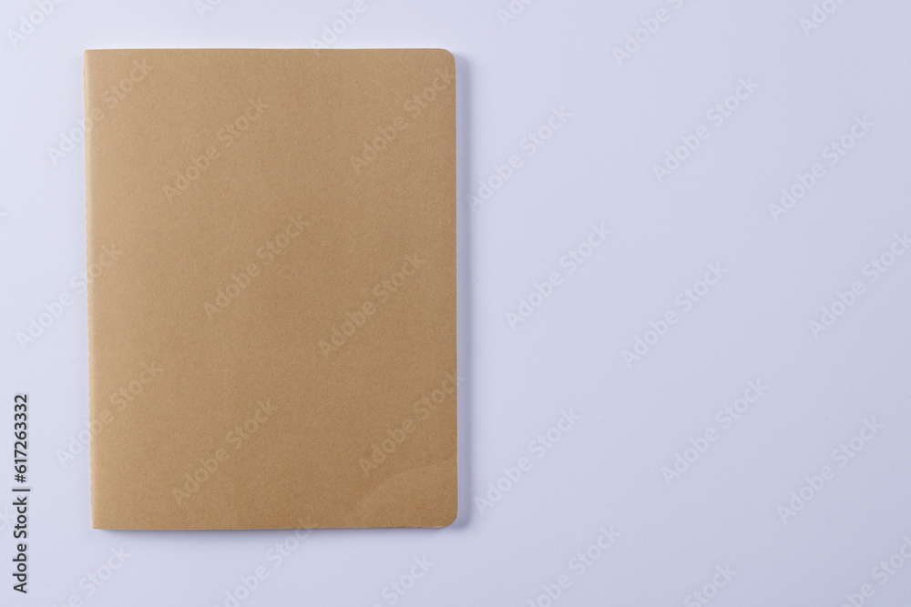 Close up of beige notebook with copy space on white background Close up of beige notebook with copy space on white background