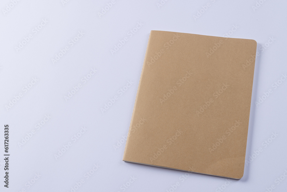 Close up of beige notebook with copy space on white background Close up of beige notebook with copy space on white background