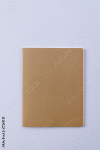 Close up of beige notebook with copy space on white background