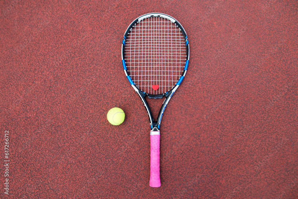 tennis racket and ball on the field.