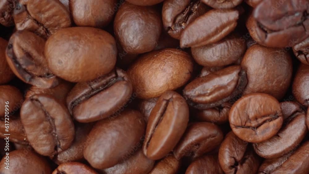 Natural roasted coffee bean close up heap beans. Selective focus, slow motion Natural roasted coffee bean close up heap beans. Selective focus, slow motion