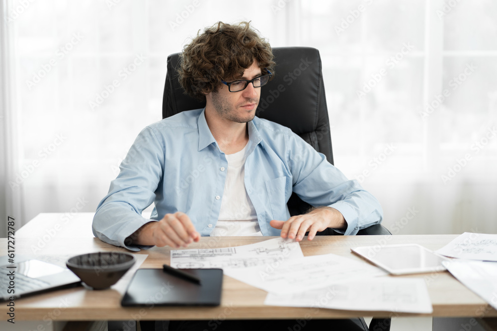 Caucasian businessman working with paper work in office Caucasian businessman working with paper work in office