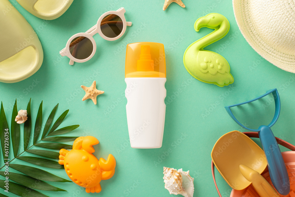 The concept of ultraviolet protection during your getaway with kids with this top view image, displaying sunscreen cream, beach toys, slippers, panama, sunglasses and palm leaf on teal backdrop The concept of ultraviolet protection during your getaway with kids with this top view image, displaying sunscreen cream, beach toys, slippers, panama, sunglasses and palm leaf on teal backdrop