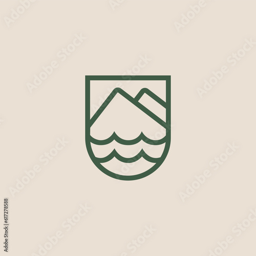 Mountain and waves logo in shield frame