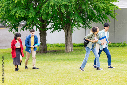 Multinational youth group walking in outdoor facility.