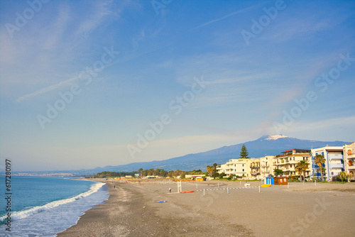 Fototapeta Naklejka Na Ścianę i Meble -  Beach in Recanati near Giardini Naxos, Taormina, Sicily, Italy, with Entna in the background
