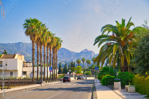 Street in Recanati, a town near Giardini Naxos, with Taormina in the background, Sicily, Italy