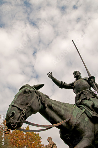Madrid, Spain, Europe - Monument to Cervantes in Plaza de España, in front bronze statues of Don Quixote and Sancho Panza  photo
