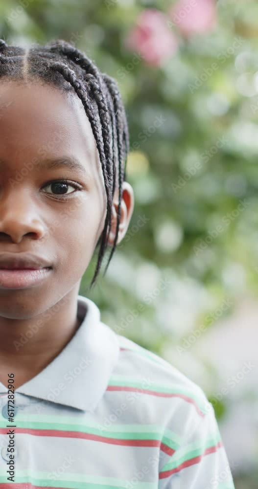Vertical video of half portrait of happy african american boy in nature, slow motion Vertical video of half portrait of happy african american boy in nature, slow motion