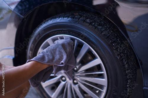 mechanic changing wheel of car