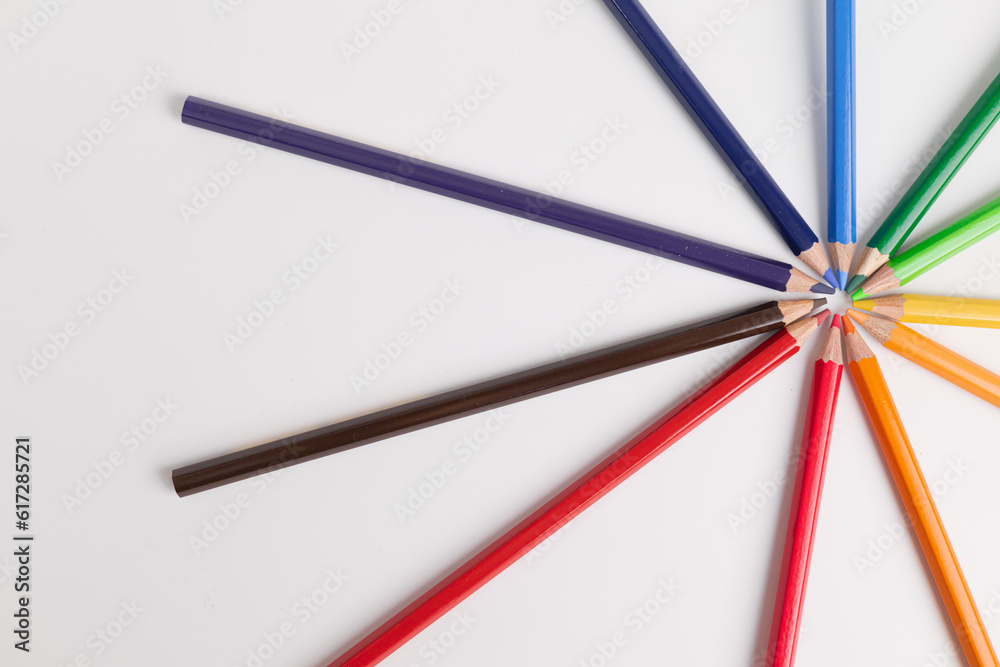 Fototapeta premium Circle of colored pencils on a white background. colorful and brightness concept. Pride Month. gender diversity. cultural diversity. free space for advertising. backdrop for advertising.