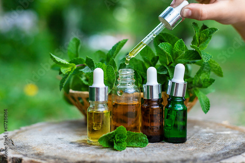 Peppermint essential oil in a bottle. Selective focus.