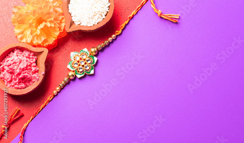 Raksha Bandhan, Indian festival with beautiful Rakhi and Rice Grains.  A traditional Indian wrist band which is a symbol of love between Sisters and Brothers.