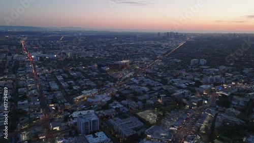 Wallpaper Mural Nice view of large city from height. Long straight street with car lights intersecting metropolis at sunset. Torontodigital.ca