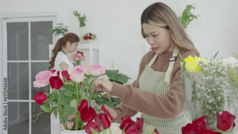 Two beautiful Asian florists work together in her own shop. Small business, Owner business. Two beautiful Asian florists work together in her own shop. Small business, Owner business.