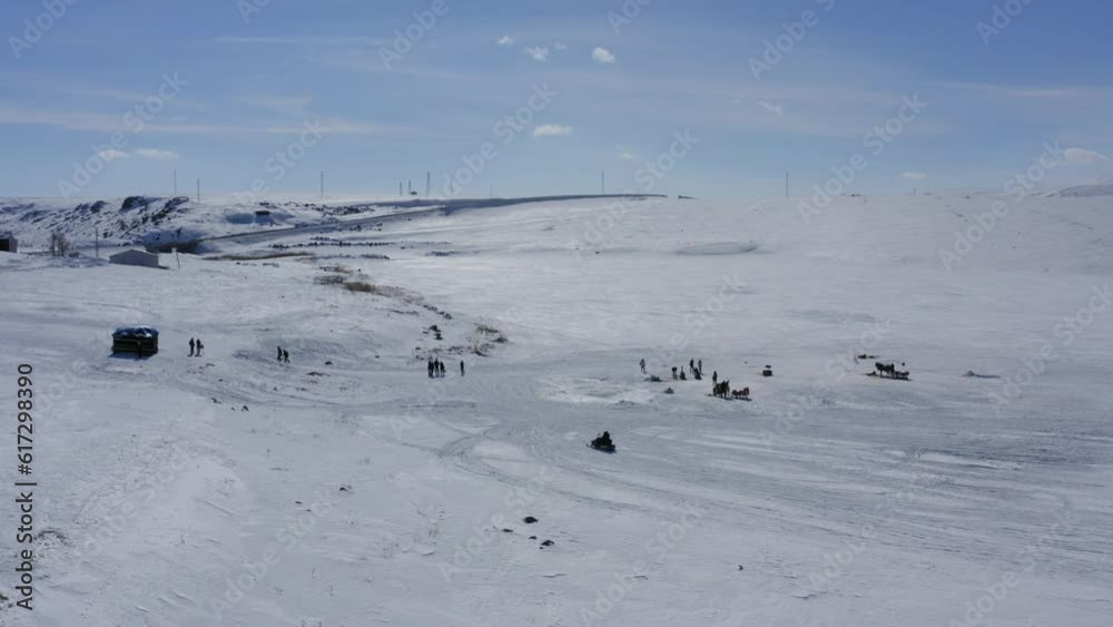 Snow mobile on frozen cildid lake in Turkey on white landscape Snow mobile on frozen cildid lake in Turkey on white landscape