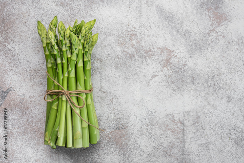 Fresh green asparagus on concrete background.