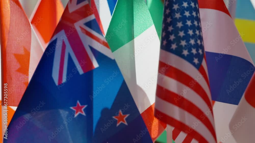 Close-up United Kingdom and United States flags at background of other countries national flags. Concept of political cooperation and international unity Close-up United Kingdom and United States flags at background of other countries national flags. Concept of political cooperation and international unity