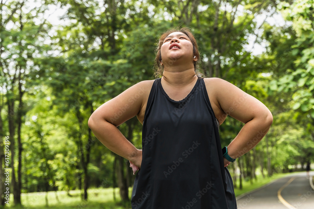Fat sport Woman feeling tired after doing exercise in nature park, oversized woman workout in park Fat sport Woman feeling tired after doing exercise in nature park, oversized woman workout in park