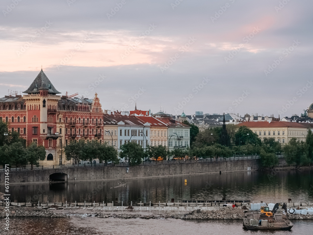 Obraz premium Old houses on the Vltava embankment in Prague. Beautiful old city. Multicolored facades of houses in a European city
