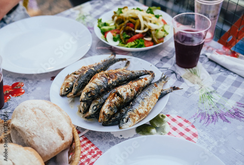 Wallpaper Mural Grilled sardines on a plate, bread, salad, festival "Santos Populares" in Lisbon, Aflama Torontodigital.ca