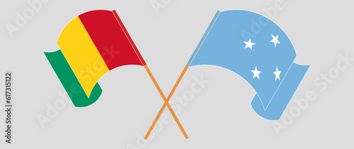 Crossed and waving flags of Guinea and Micronesia