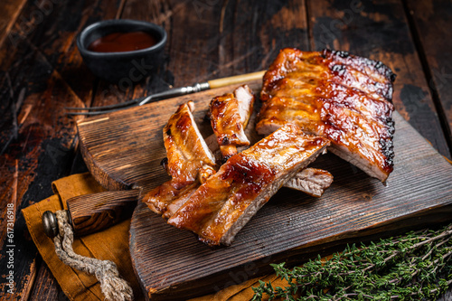 Grilled pork Baby Back spare ribs on a wooden board. Wooden background. Top view